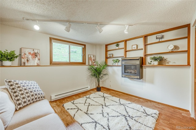 140 Forest Dr, Frisco, CO 80443 - sitting room with track lighting, baseboard heating, a textured ceiling, light wood-style floors, and baseboards