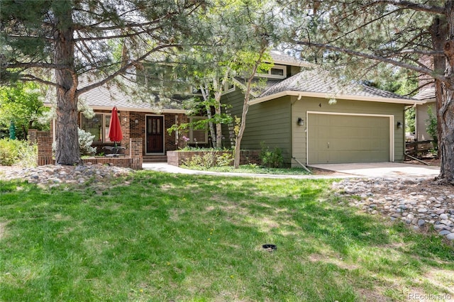 view of front of property with a front lawn, concrete driveway, and an attached garage
