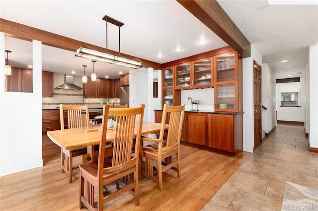 dining space with recessed lighting, baseboards, and light wood-style flooring