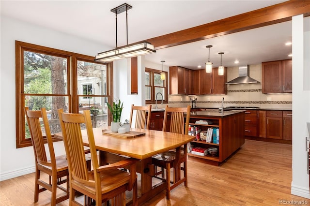 dining room with light wood finished floors, healthy amount of natural light, baseboards, and recessed lighting