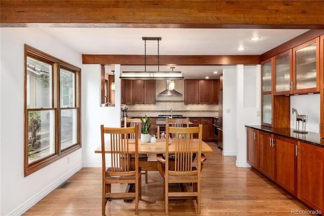 dining room with light wood finished floors, beam ceiling, baseboards, and recessed lighting