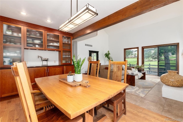dining space featuring recessed lighting, light wood-style floors, and high vaulted ceiling
