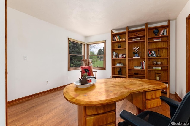 home office featuring light wood-style flooring and baseboards