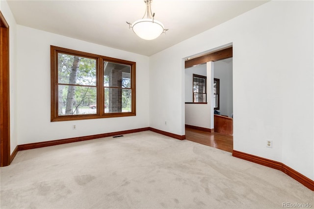 spare room with carpet flooring and baseboards