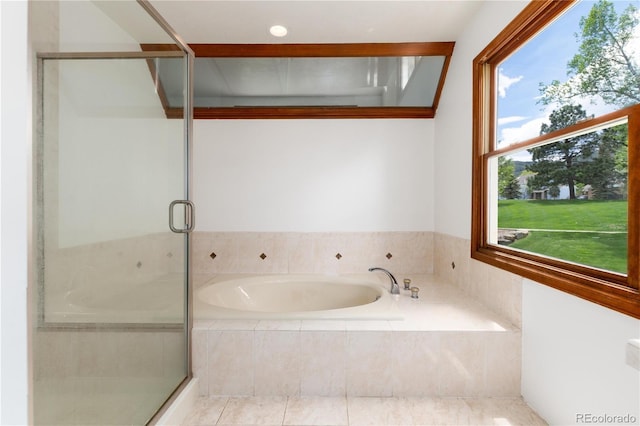 full bathroom with a stall shower and a bath