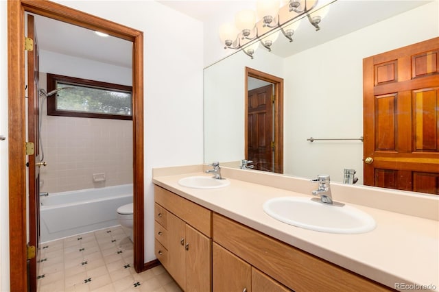 bathroom with toilet, double vanity, and bathtub / shower combination