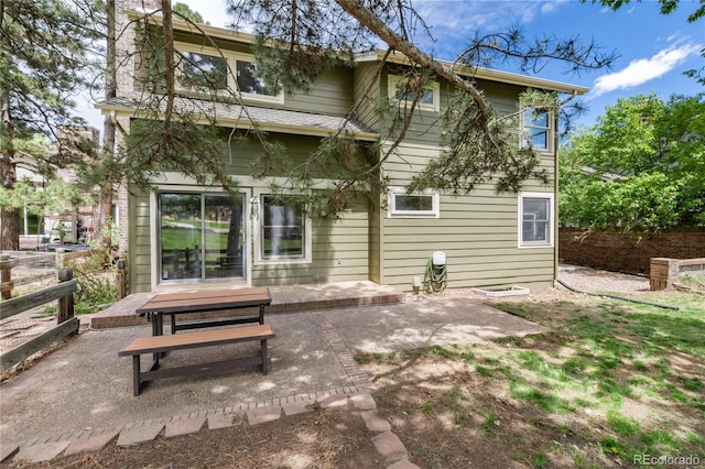 back of property featuring a patio and a chimney