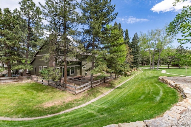 view of green lawn with a garden