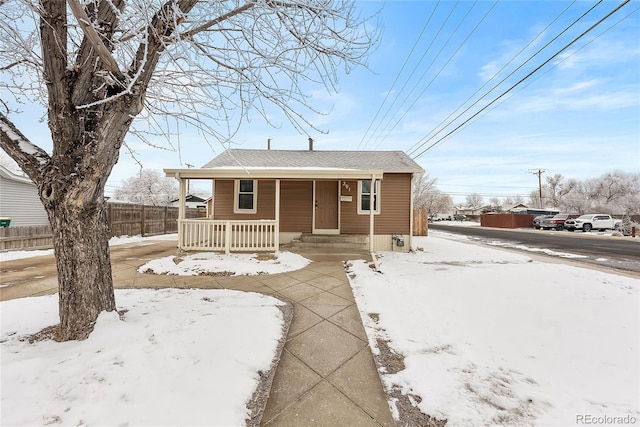 view of front of house featuring a porch and fence