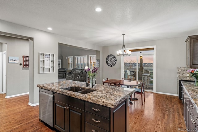 1609 S Catawba Cir, Aurora, CO 80018 - kitchen with stainless steel dishwasher, a chandelier, plenty of natural light, wood finished floors, and recessed lighting