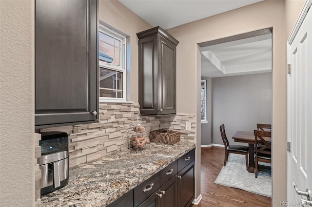 1609 S Catawba Cir, Aurora, CO 80018 - kitchen with tasteful backsplash, wood finished floors, dark brown cabinets, and light stone countertops