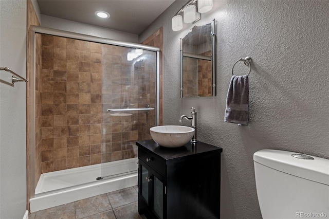 1609 S Catawba Cir, Aurora, CO 80018 - full bathroom with vanity, a stall shower, a textured wall, tile patterned flooring, and recessed lighting