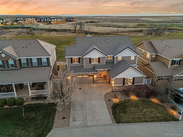 1609 S Catawba Cir, Aurora, CO 80018 - view of front of home featuring stone siding, driveway, a garage, and board and batten siding