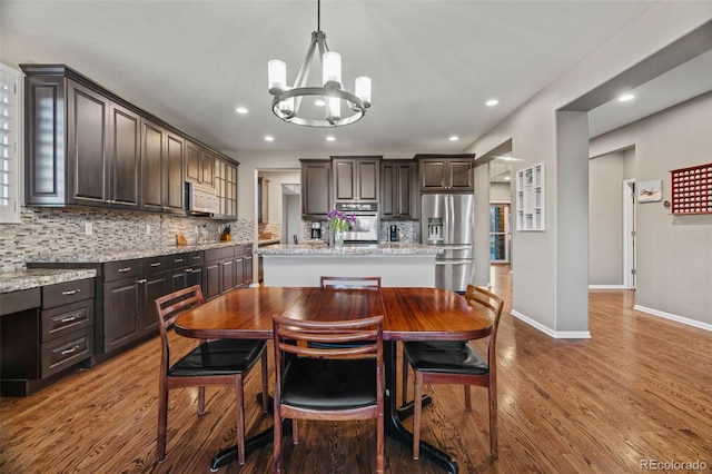 1609 S Catawba Cir, Aurora, CO 80018 - dining area featuring a chandelier, wood finished floors, and recessed lighting