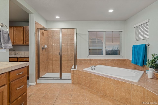 1609 S Catawba Cir, Aurora, CO 80018 - full bathroom with a bath, a stall shower, tile patterned flooring, vanity, and recessed lighting