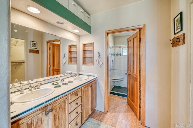 11855 County Road 251a, Salida, CO 81201 - full bathroom featuring a shower stall, double vanity, wood finished floors, and a spacious closet