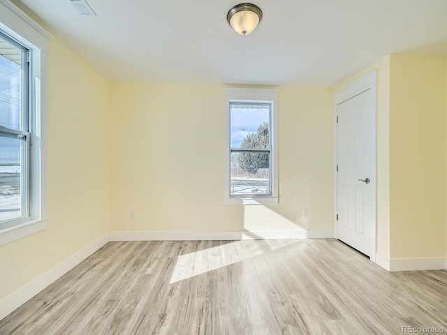 spare room with light hardwood / wood-style flooring