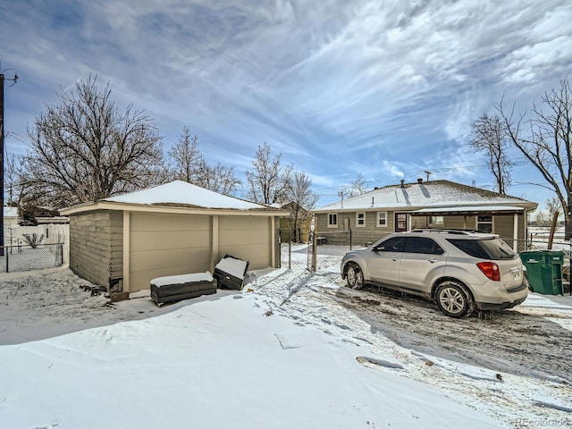 view of snow covered exterior featuring a garage