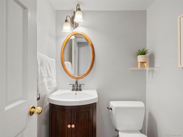 bathroom with toilet and vanity