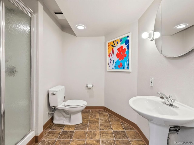 bathroom featuring tile patterned flooring, walk in shower, and toilet