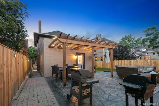 back house at dusk featuring an outdoor living space, a patio area, and a pergola