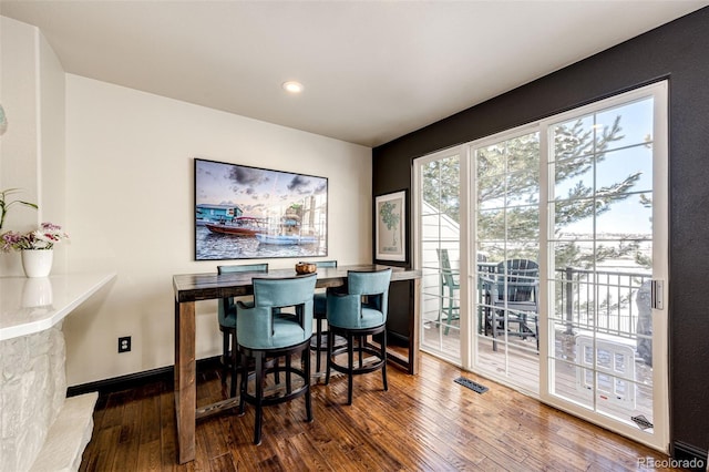 dining space featuring dark hardwood / wood-style flooring