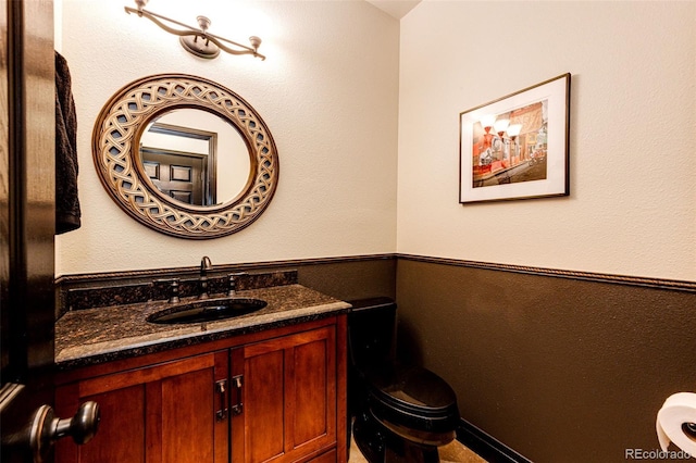 bathroom with toilet and vanity