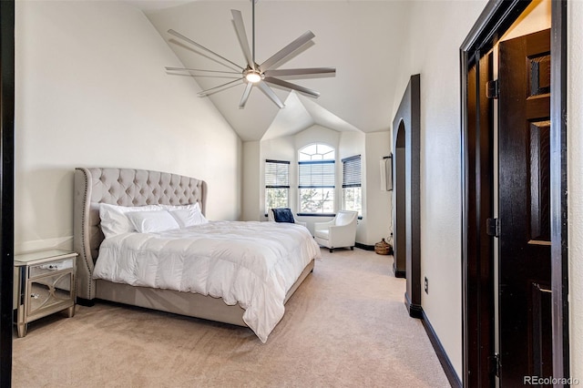 carpeted bedroom with ceiling fan and vaulted ceiling