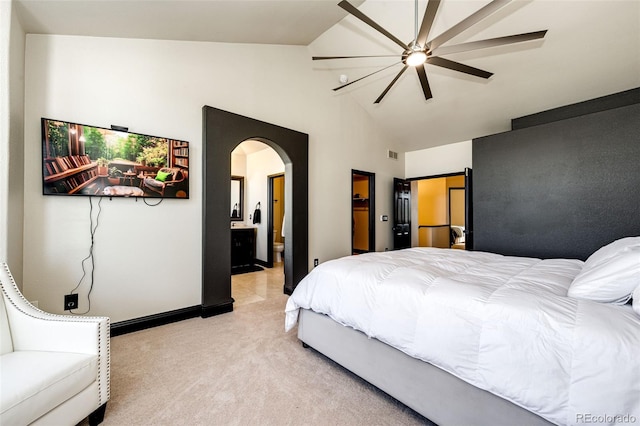 bedroom with ceiling fan, light colored carpet, and vaulted ceiling