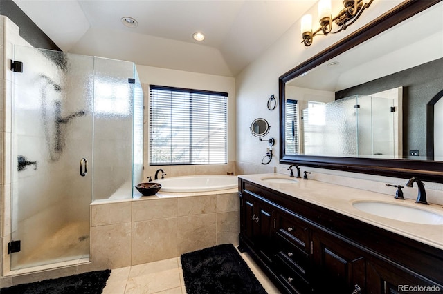 bathroom featuring plus walk in shower, tile patterned floors, lofted ceiling, and vanity