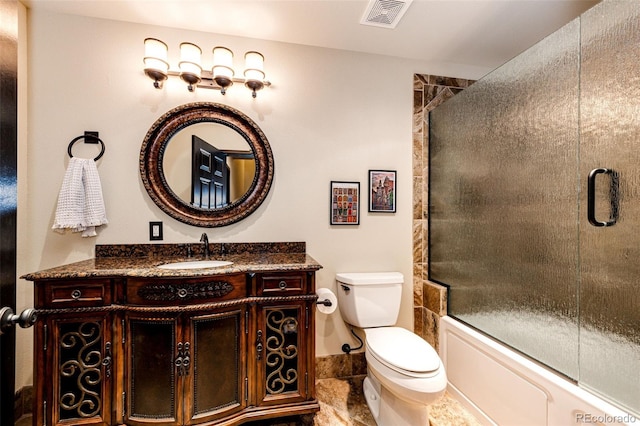 full bathroom featuring vanity, toilet, and bath / shower combo with glass door