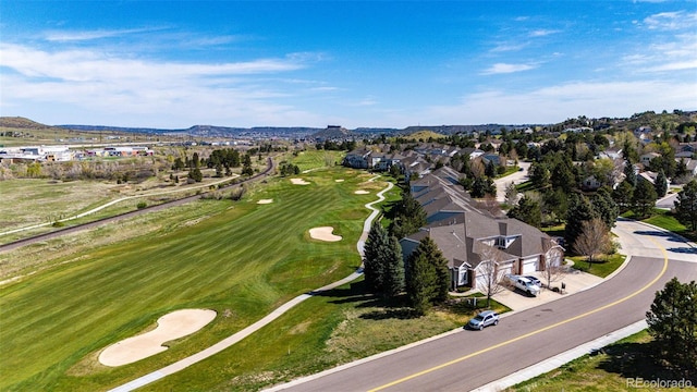 aerial view of residential area with a local golf course and a mountainous background