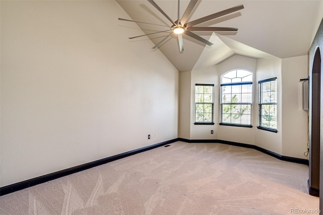 unfurnished room with light carpet, a ceiling fan, lofted ceiling, and baseboards
