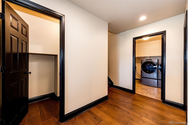 hall featuring washer and dryer, wood finished floors, baseboards, and recessed lighting