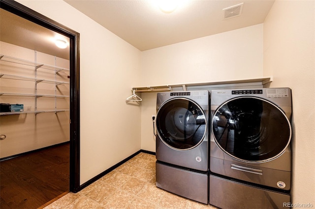 laundry area featuring separate washer and dryer and baseboards