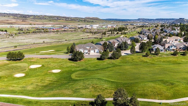 aerial perspective of suburban area featuring a golf club and a mountainous background
