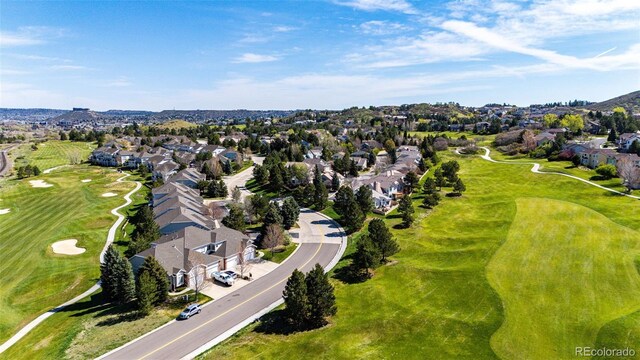 aerial view of property's location featuring nearby suburban area and a golf course