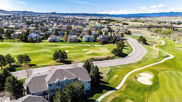 aerial perspective of suburban area featuring a mountain backdrop and a golf course