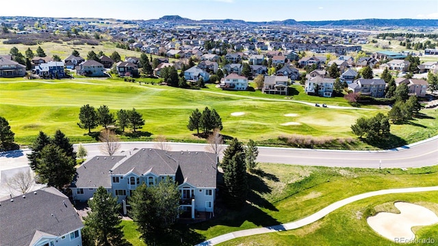 aerial view of residential area with a golf club and a mountain backdrop