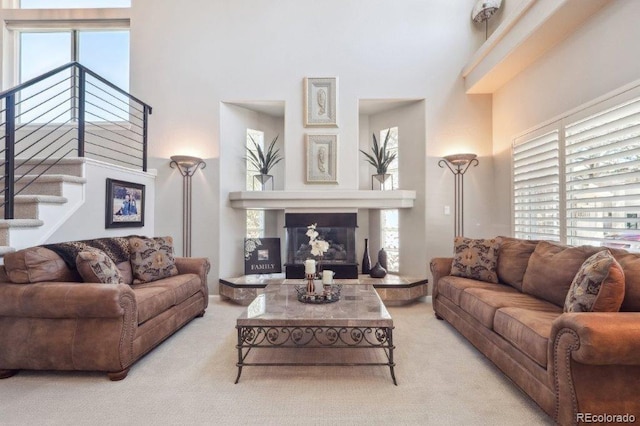 9531 Desert Willow Way, Highlands Ranch, CO 80129 - living room featuring a high ceiling, carpet floors, a fireplace, and stairway