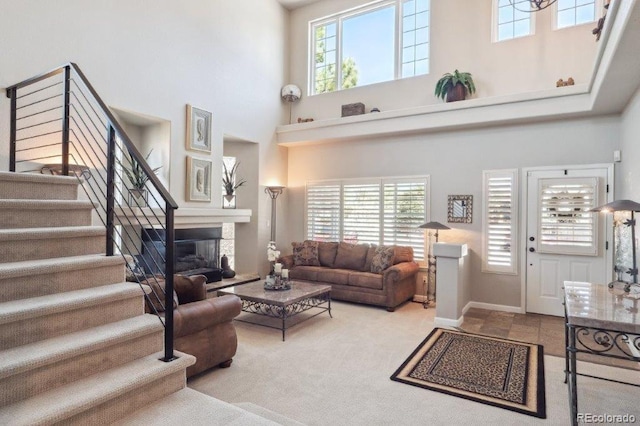 9531 Desert Willow Way, Highlands Ranch, CO 80129 - living area with a towering ceiling, stairs, plenty of natural light, carpet floors, and baseboards