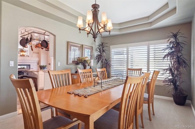 9531 Desert Willow Way, Highlands Ranch, CO 80129 - dining room featuring a chandelier, light carpet, arched walkways, and baseboards
