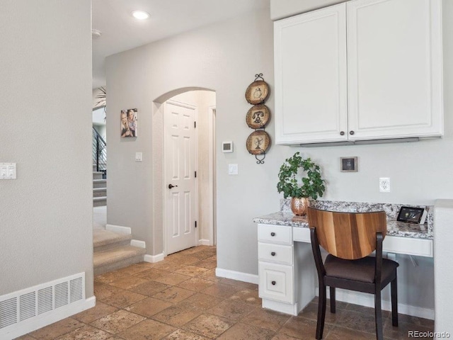 9531 Desert Willow Way, Highlands Ranch, CO 80129 - office area with arched walkways, baseboards, stone tile floors, and recessed lighting