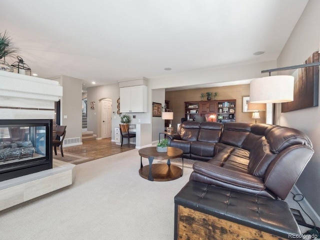 9531 Desert Willow Way, Highlands Ranch, CO 80129 - carpeted living area with arched walkways, baseboards, and a multi sided fireplace