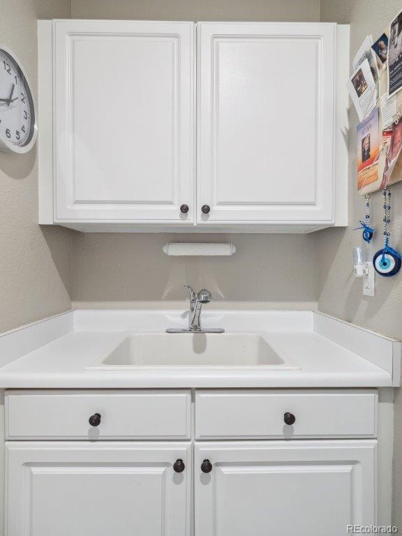 9531 Desert Willow Way, Highlands Ranch, CO 80129 - kitchen with a sink, white cabinets, and light countertops