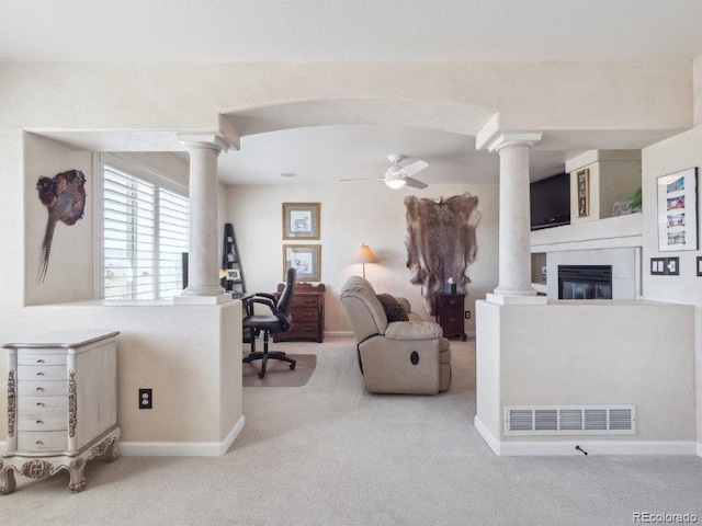 9531 Desert Willow Way, Highlands Ranch, CO 80129 - living room with ornate columns, carpet floors, ceiling fan, and a fireplace