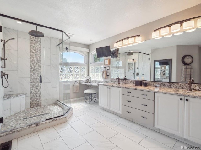 9531 Desert Willow Way, Highlands Ranch, CO 80129 - full bathroom with a stall shower, double vanity, marble finish floors, and a textured ceiling