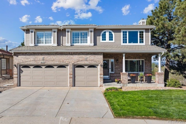 9531 Desert Willow Way, Highlands Ranch, CO 80129 - view of front of home with concrete driveway, a chimney, a front lawn, a porch, and an attached garage
