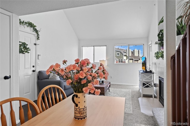 970 S Dawson Way Unit 9, Aurora, CO 80012 - dining area with lofted ceiling, carpet flooring, and a fireplace with flush hearth