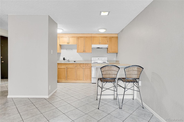 kitchen featuring light tile patterned flooring, light brown cabinetry, white range with electric stovetop, sink, and a textured ceiling